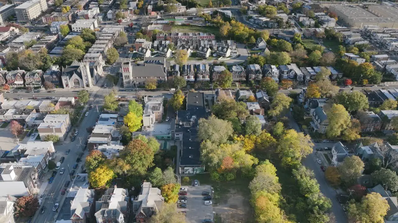 Aerial flyover of neighborhoods and streets in west Philadelphia revealing a baseball field