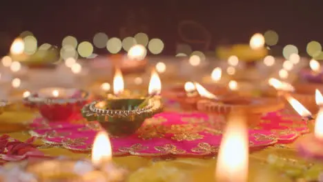 Burning Diya Lamps On Table Decorated To Celebrate Festival Of Diwali