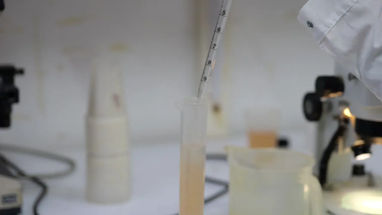 Scientist preparing water sample with pipette