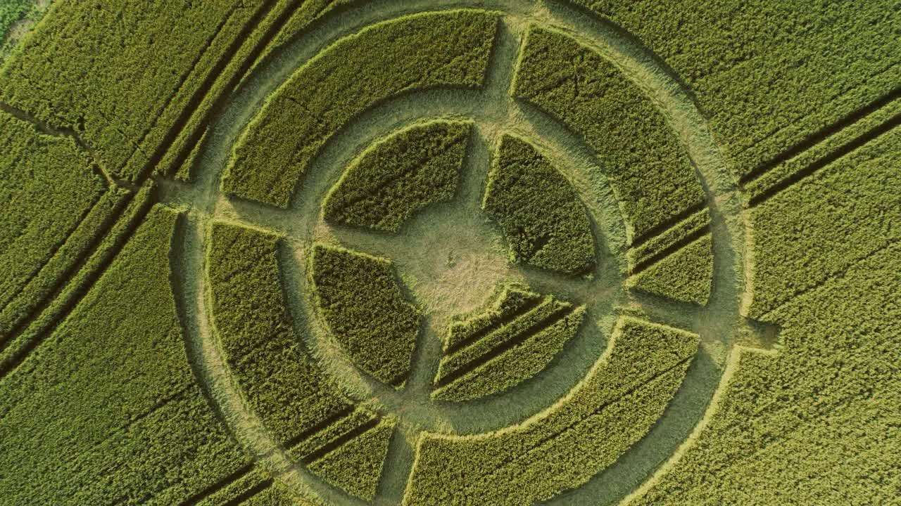 Hackpen hill strange crop circle pattern in rural grass farming meadow aerial view rising birdseye