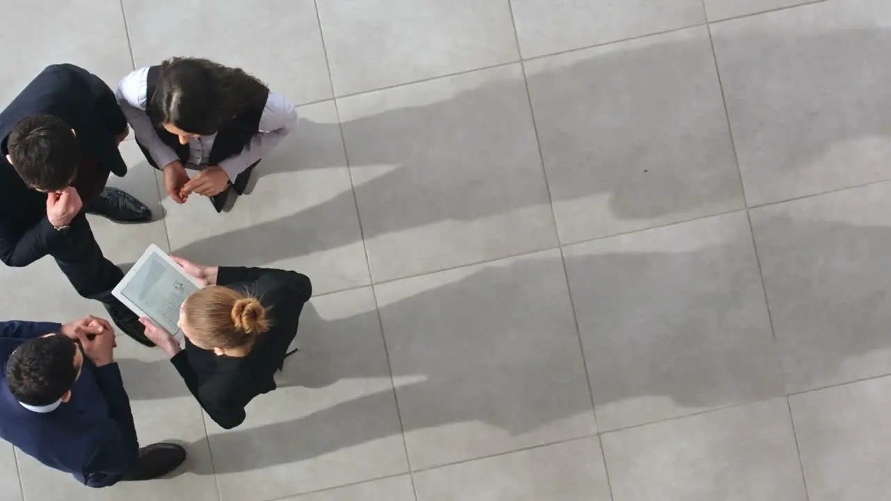 Top View Of Group Of Workers In Stylish Clothes Talking In Hall Of Office Building