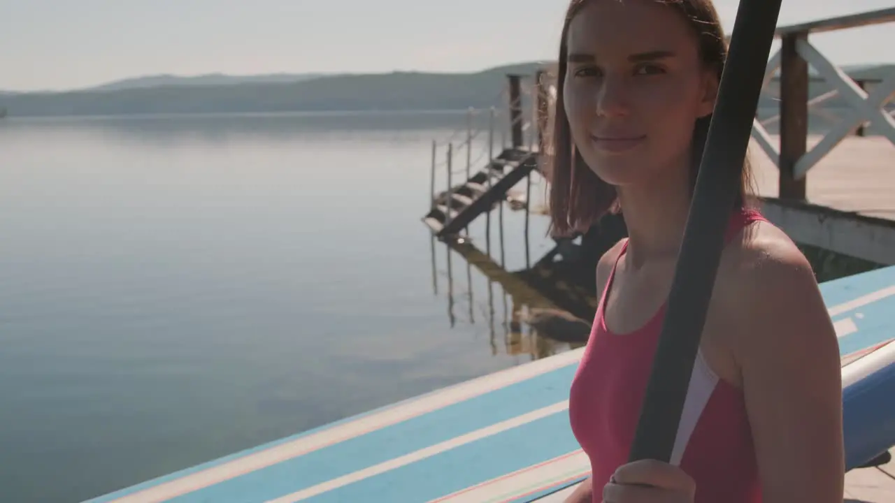 Close Up View Of Brunette Girl In A Red Swimsuit Holding A Paddle