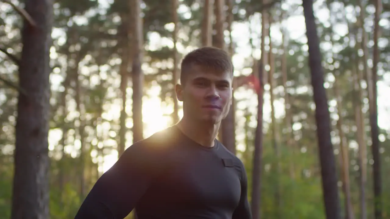 Portrait Of A Handsome Sportive Man Smiling And Looking At Camera In The Forest