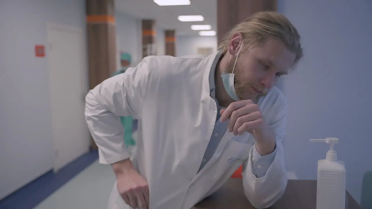 An Exhausted Young Doctor With Long Blond Hair Is Very Stressed Out After A Difficult Day Of Bad News