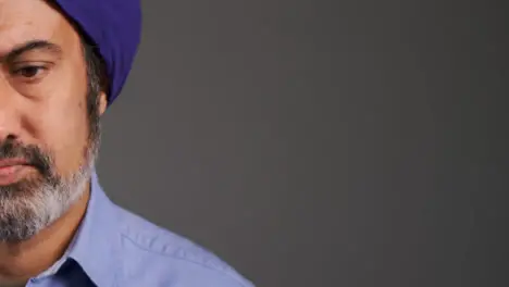 Middle Aged Man In Turban Visibly Concerned with Copy Space