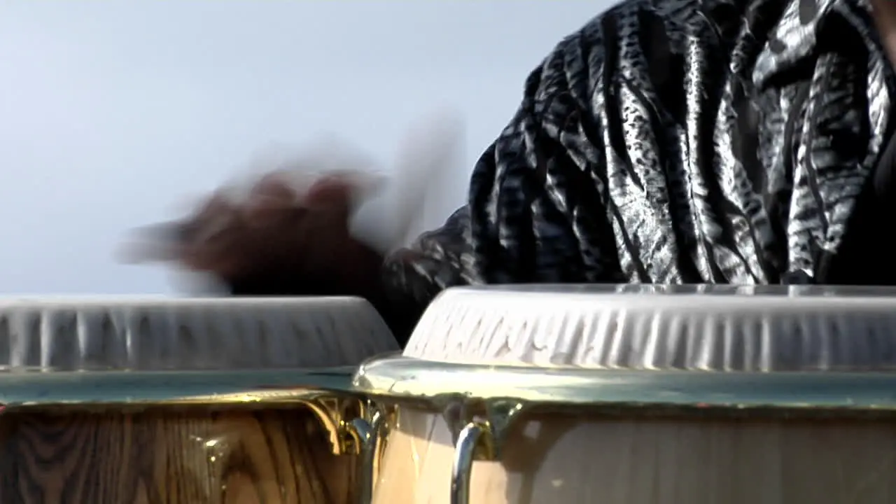 A man plays the bongo drums