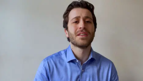 Young Male University Lecturer Teaching Video Lecture and Looking Amused