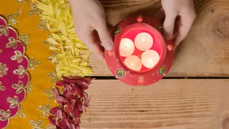 Clay Pot With Lights Being Used To Celebrate Indian Wedding Diwali Or Navratri On Decorated Table