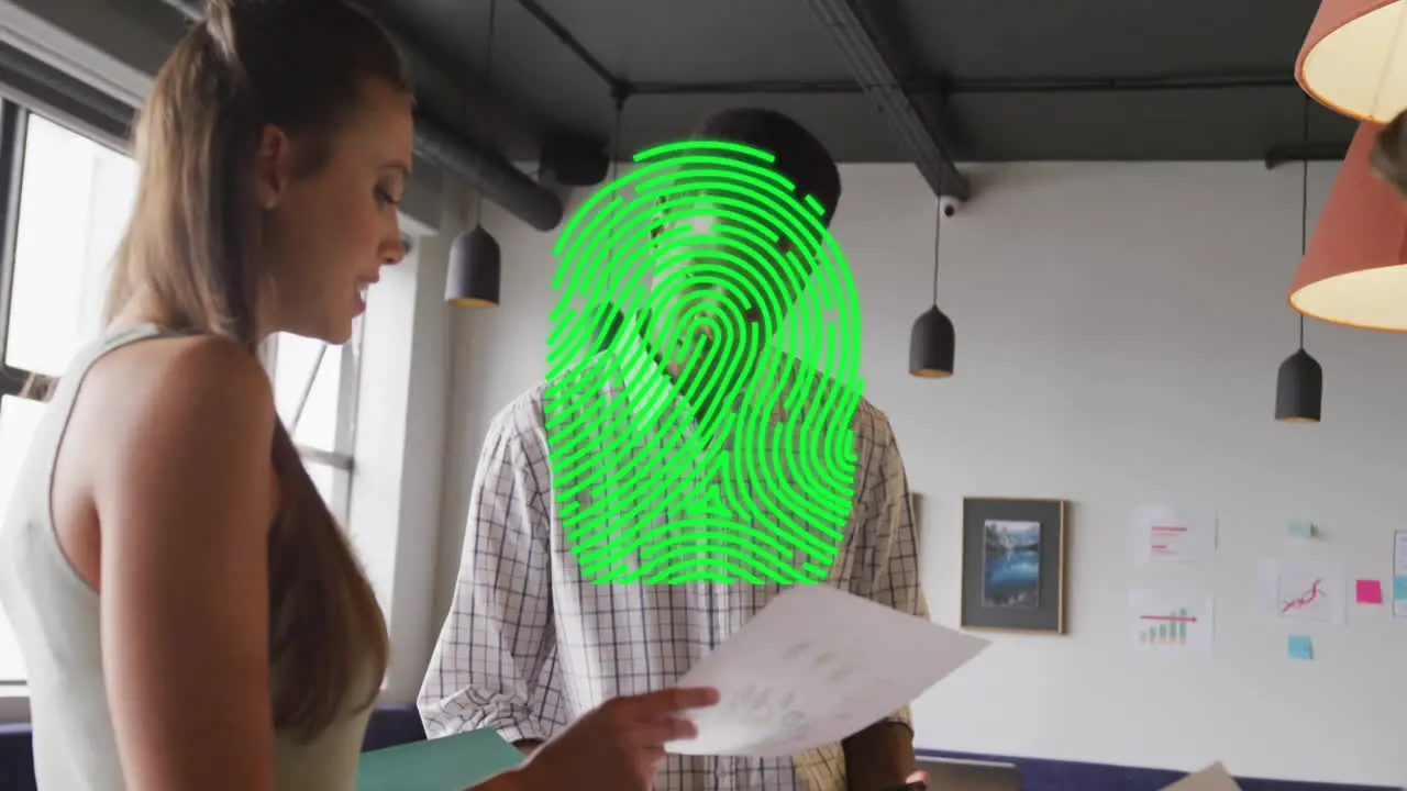 Animation of fingerprint over diverse colleagues working in creative office