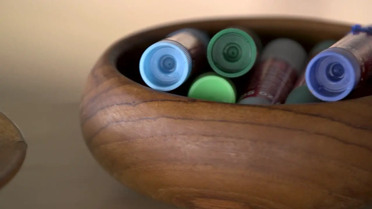 Oil pastels and glue sticks in wooden bowls