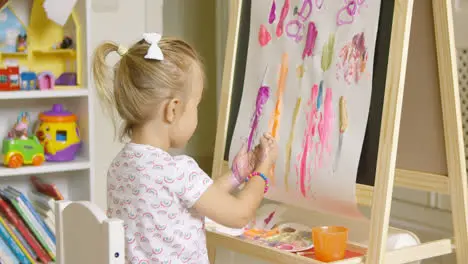 Artistic little girl painting a creative design