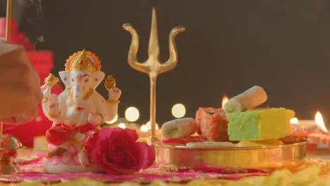 Person Holding Incense Stick With Decorations Celebrating Festival Of Diwali