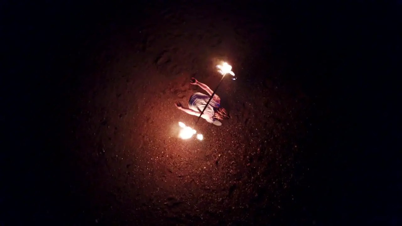 Aerial Drone Shot of Man Fire Dancing on Brighton Beach