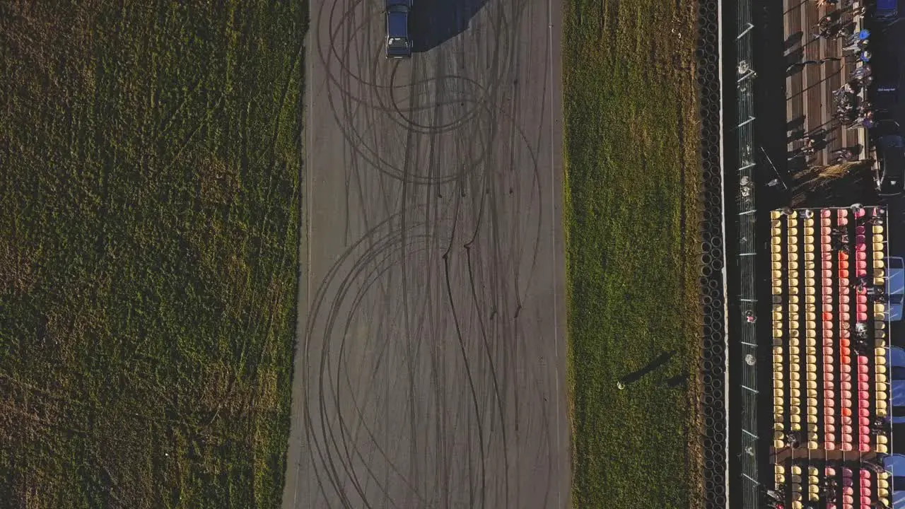 Two drag racing cars starting a race aerial tracking shot with going wide and up in the air top down shot