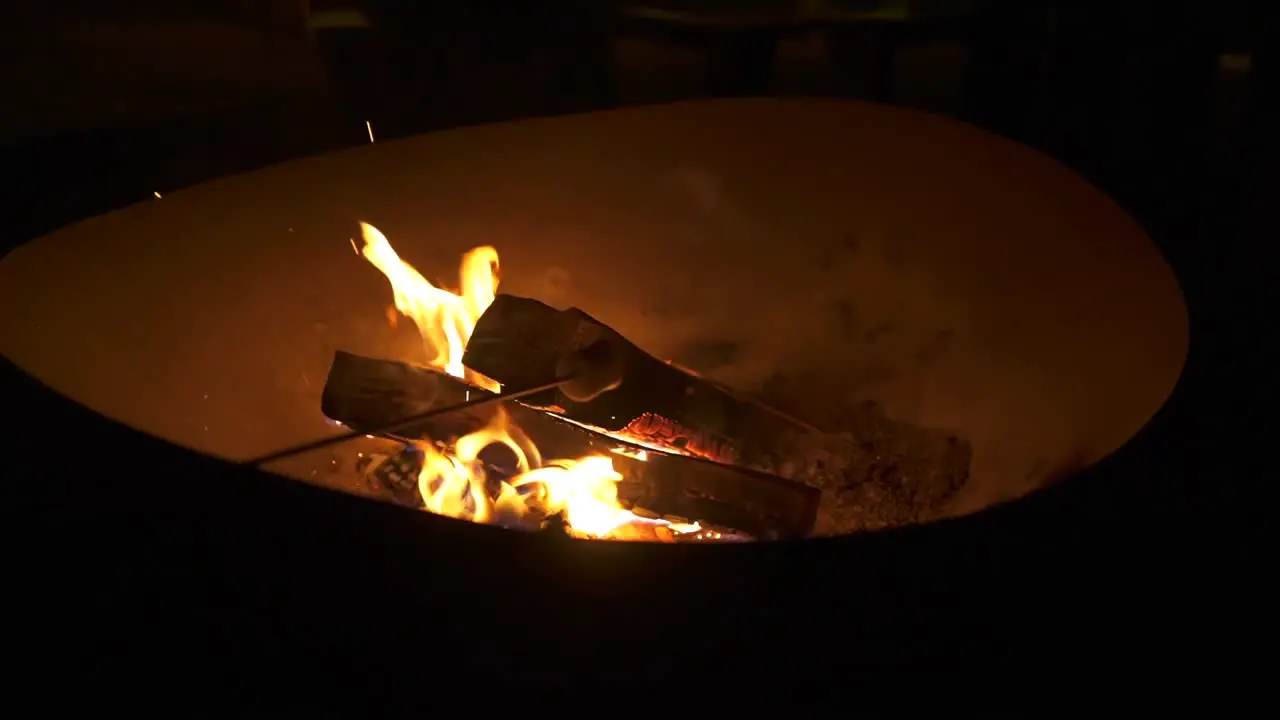 Marshmallow roasting in on open flame at campfire close up