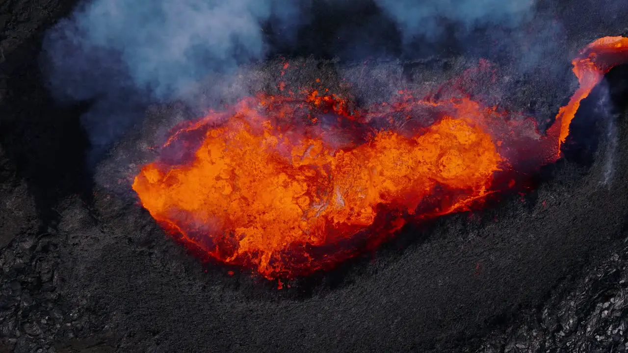 Top down of volcano crater ejecting hot molten lava fiery explosion