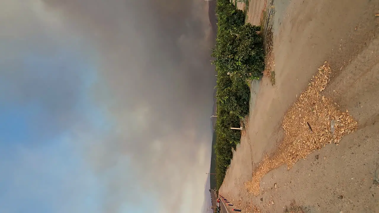 View of destructive wildfire next to road evacuation of the fire area natural disaster