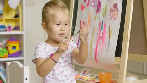 Cute girl artist creating a colorful abstract