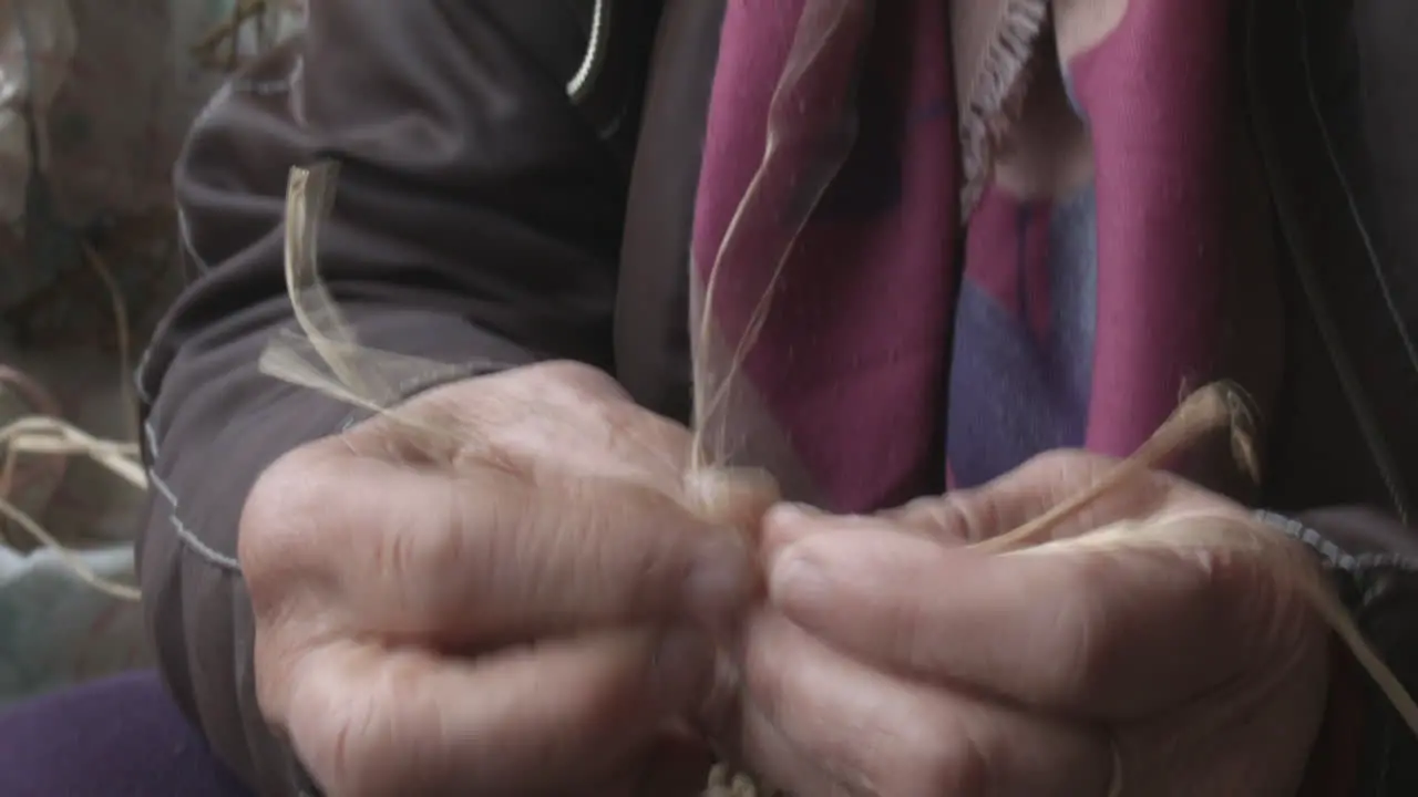 Elderly individual using their hands and skills to create something