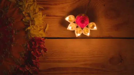 Person Holding Five Wick Lamp On Table Decorated To Celebrate Festival Of Diwali 1