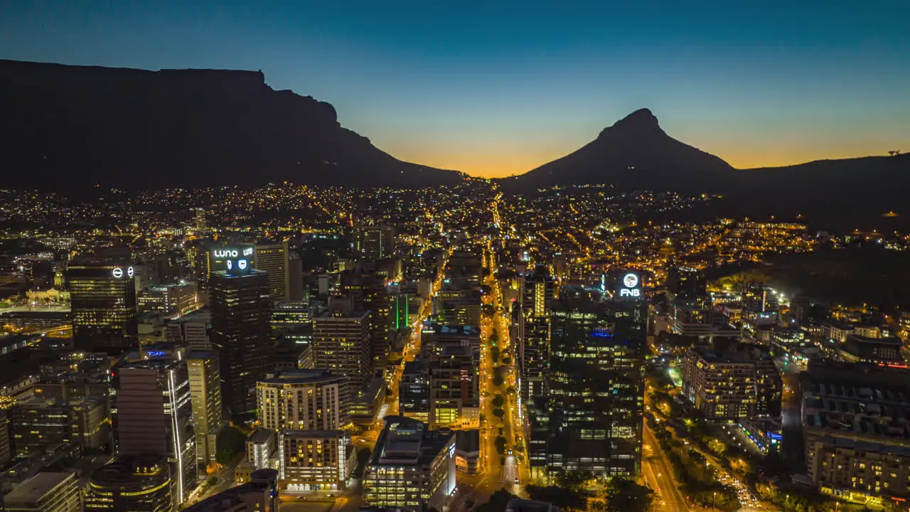 Evening aerial hyperlapse shot of downtown Silhouette of mountain ridge in background South Africa