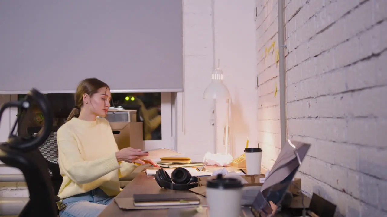 Female Employee Sitting In Office Chair And Using Tablet