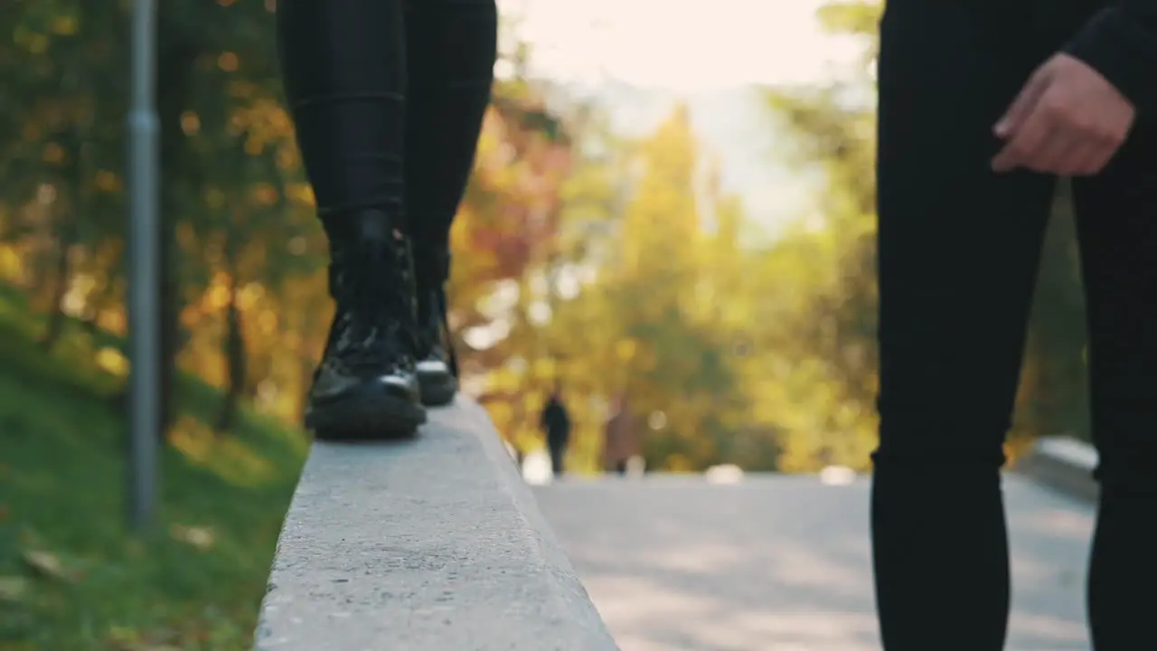 Woman's Boots Walking On A Curb