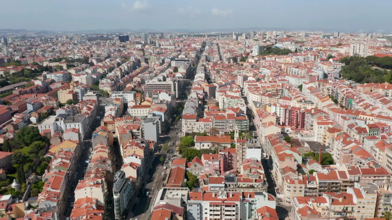 Wide aerial panoramic view of colorful houses with orange rooftops in urban city center of Lisbon