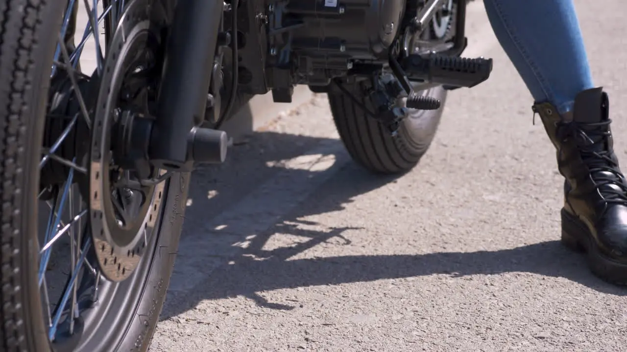 Close Up Of An Unrecognizable Moto Biker Picking The Kickstand Up And Being Ready To Go