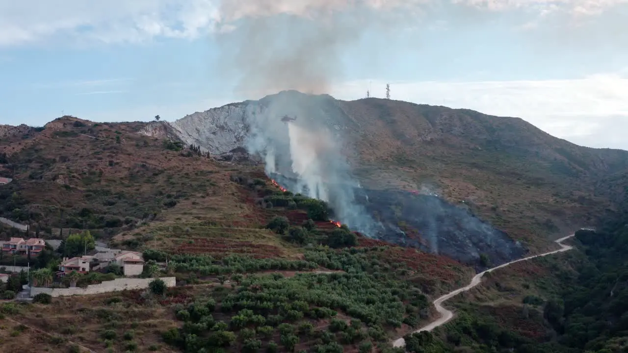 Firefighting Helicopter Battles Wildfire in Mountains