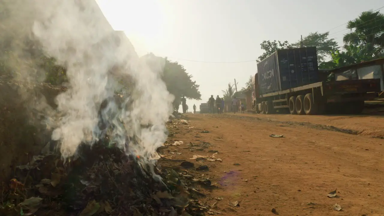 Kumasi Ghanaplastic waste burning in street corner of africa town city pollution concept