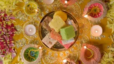 Overhead Shot Of Indian Sweets In Bowl On Table Decorated To Celebrate Festival Of Diwali