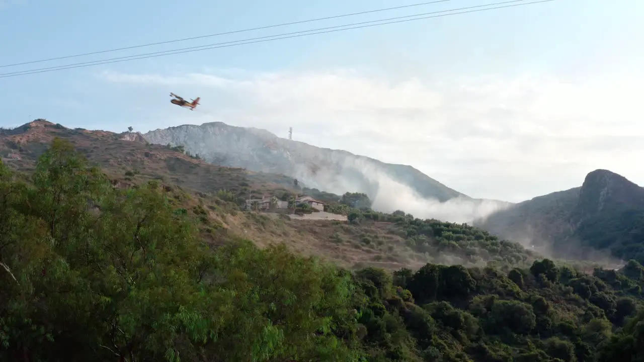 Firefighting Plane Dropping Water in Mountains