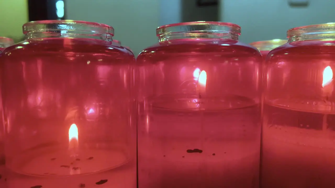 Red orthodox candles burning at a church close up