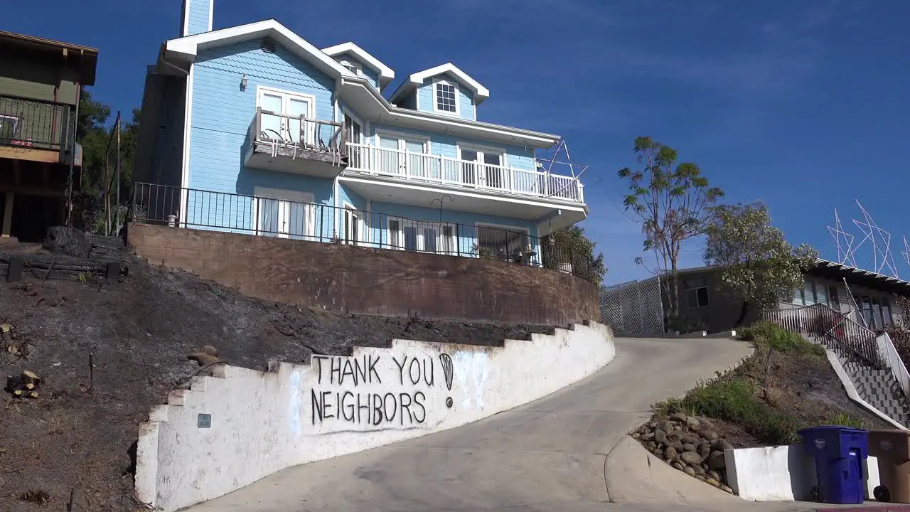 A thank you to neighbors is spray painted on a wall outside a house during the devastating Thomas Fire in Ventura California 1