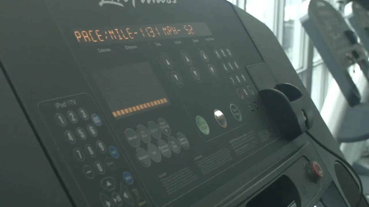 Close Up of a Man Increasing the Speed Level on a Treadmill