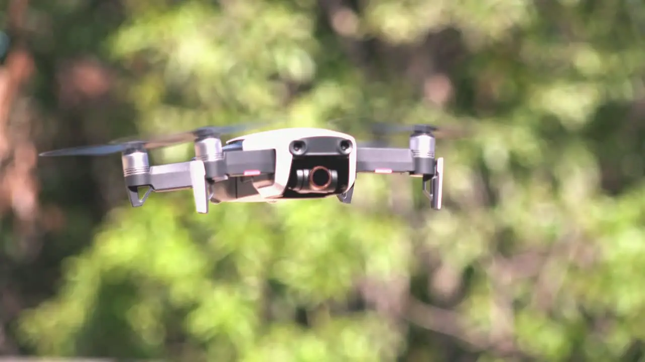 Close Shot of a Drone Flying with Trees in the Background