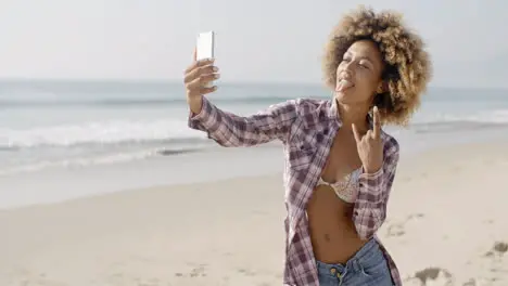 Young Woman Doing Selfie On The Beach