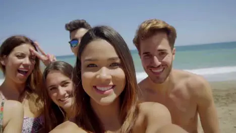 Group of Friends Taking Selfie on Sunny Beach