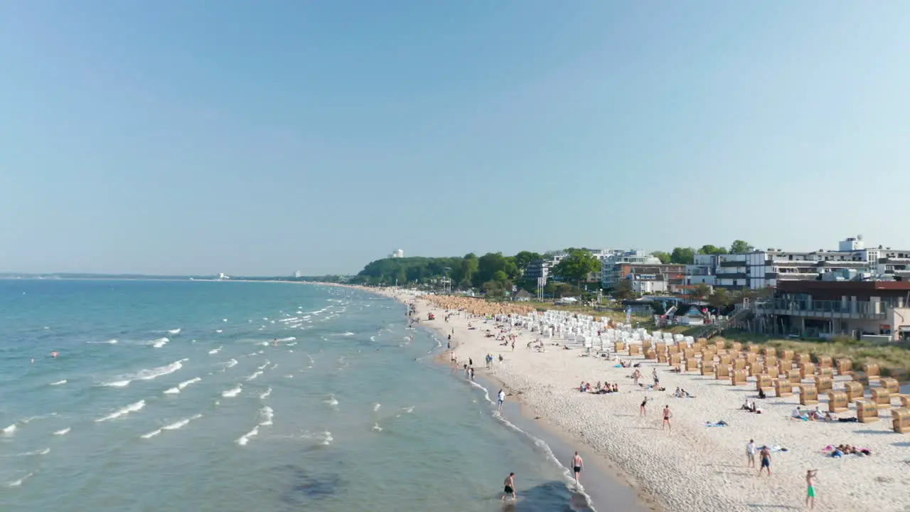 Waves crashing against tourist beach in Scharbeutz Germany sunny day