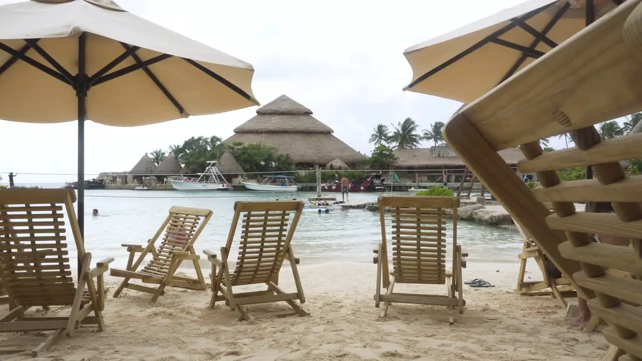 Beach beds and sun umbrella at seaside in Xcaret Cancun