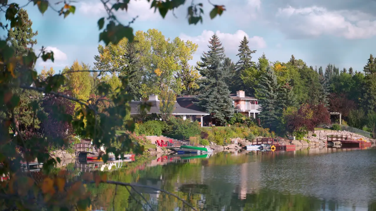 Calm lakeside view of homes on a mild summer day in Canada