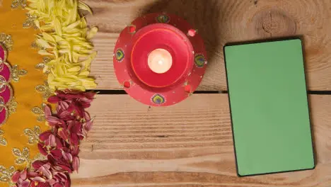 Clay Pot With Lights Being Used To Celebrate Indian Wedding Diwali Or Navratri On Decorated Table With Digital Tablet 2