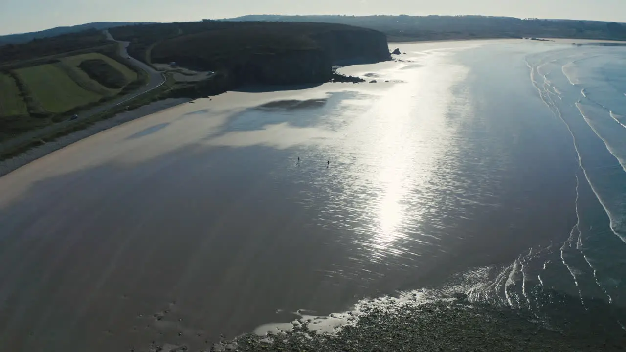 Drone view of people walking on a beach