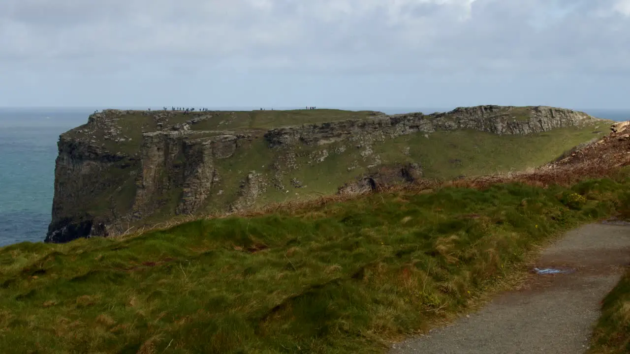 Extra Wide shot looking at Tintagel cliffs with coastal path in foreground from Lower Penhallic Tregatta