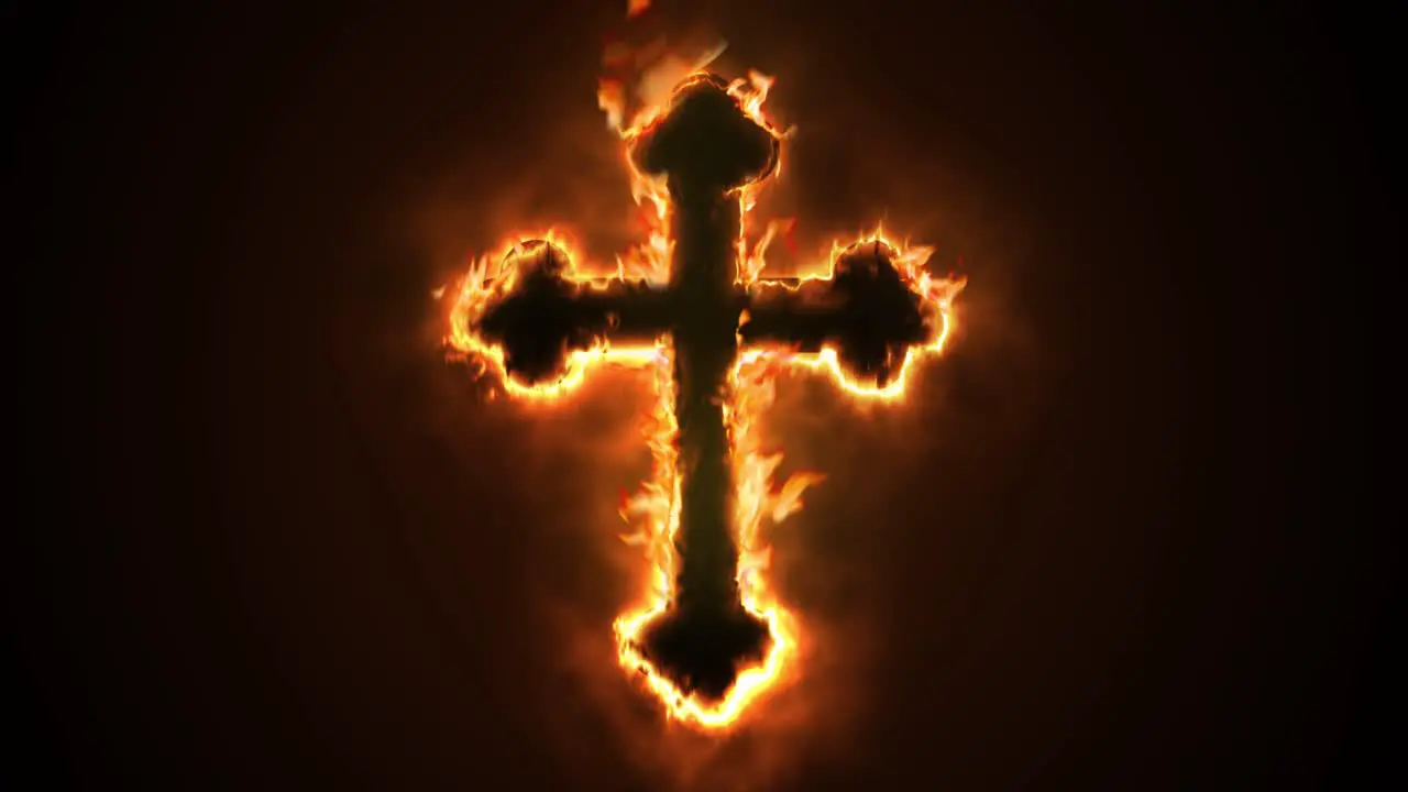 Exciting and highly emotive reveal animation of an ornate Christian Crucifix cross in roaring flames burning embers and sparks on a smokey glowing black background