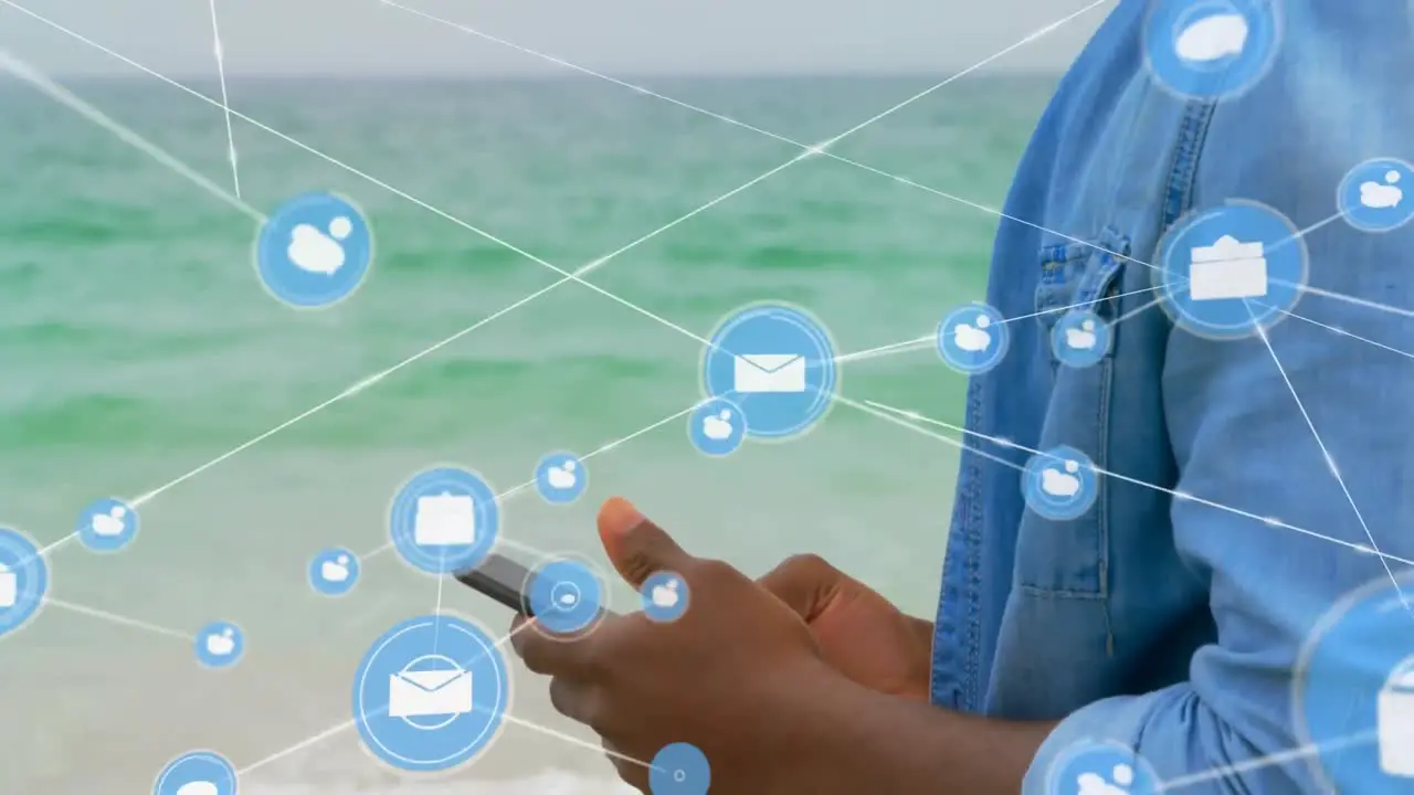 Network of digital icons against african american man using smartphone at the beach