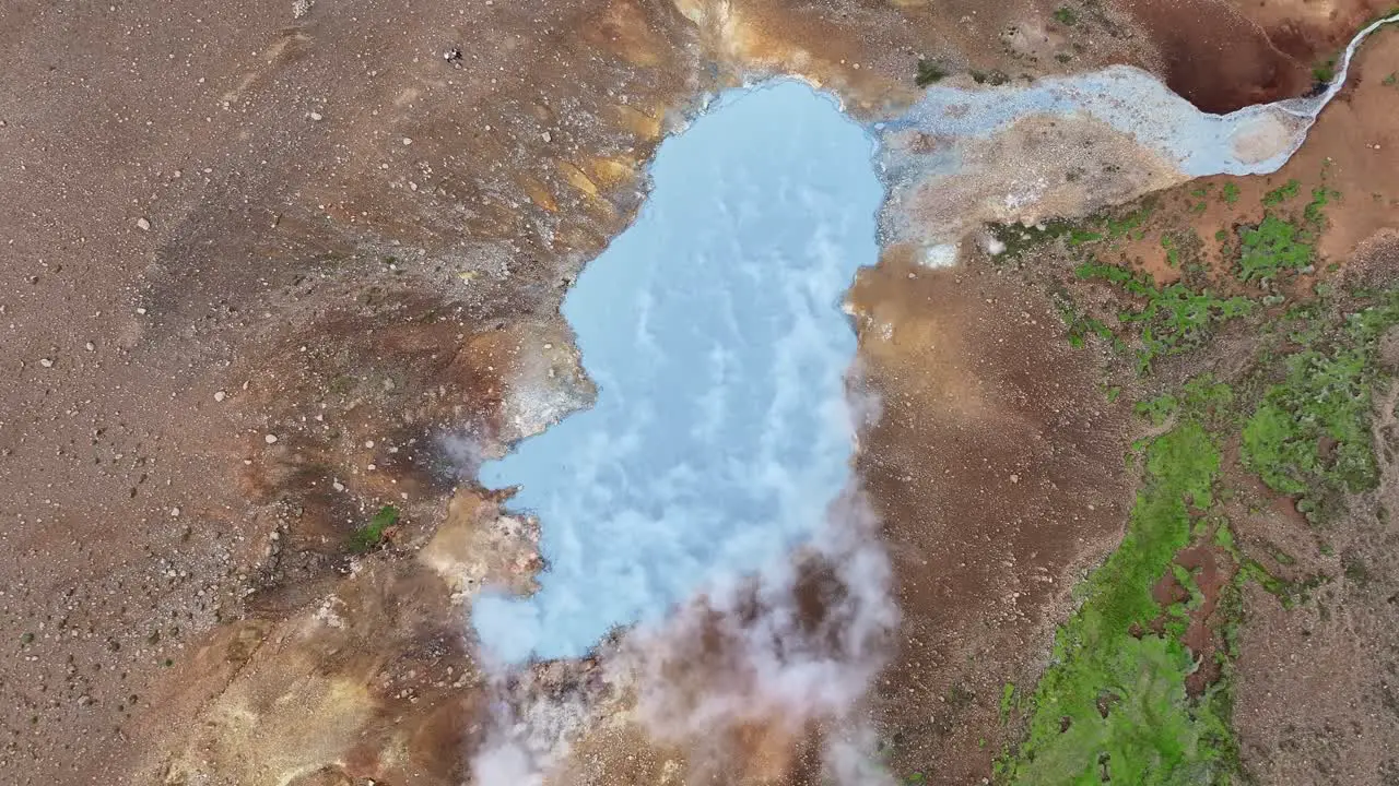 An aerial drone's ascending view from Engjahver's steam lake on the Reykjanes Peninsula in Iceland