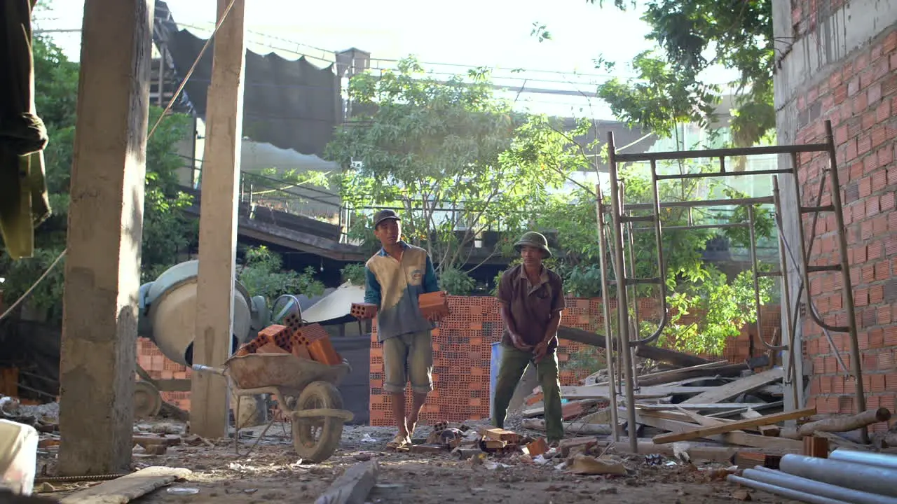 Builders throw bricks on Construction Site in Slow Motion