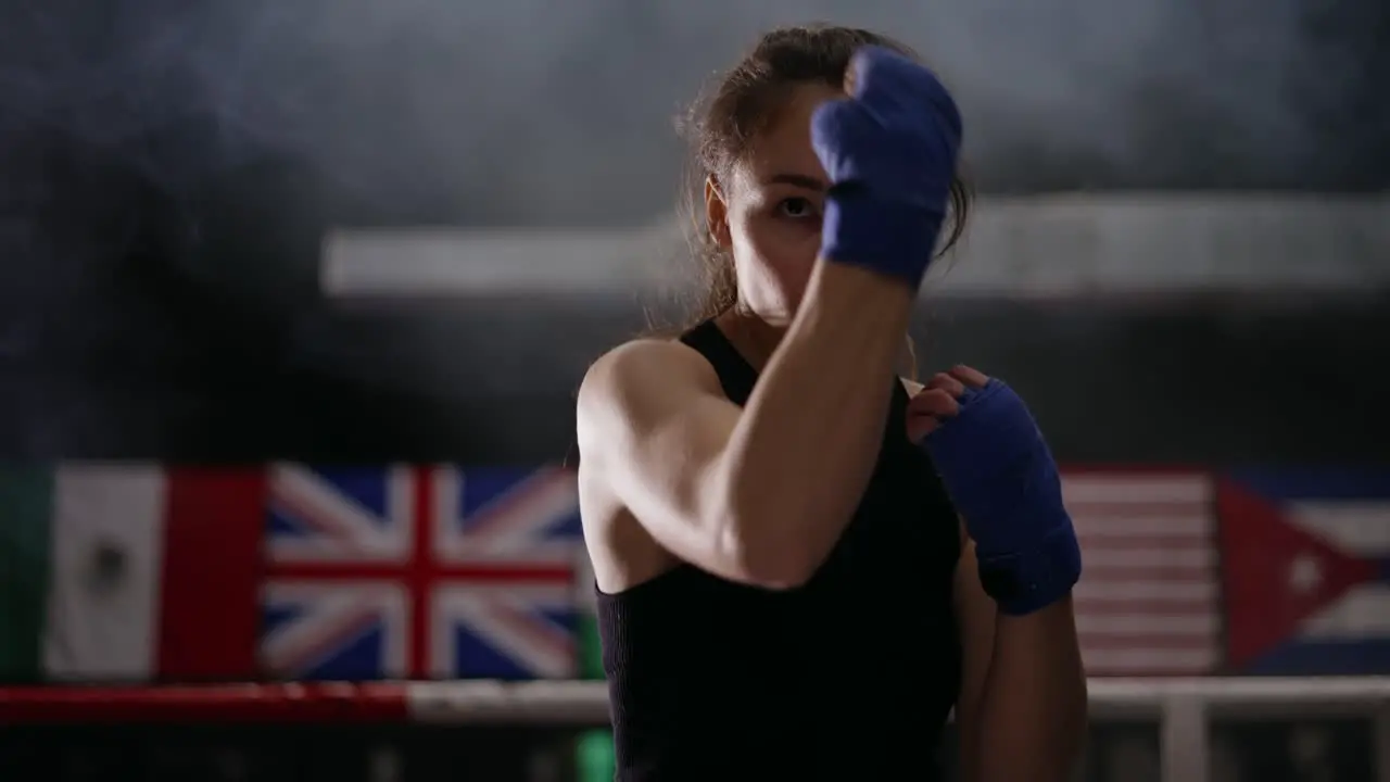 Female Boxer Performing Uppercuts In Bandages In Slow Motion Front View